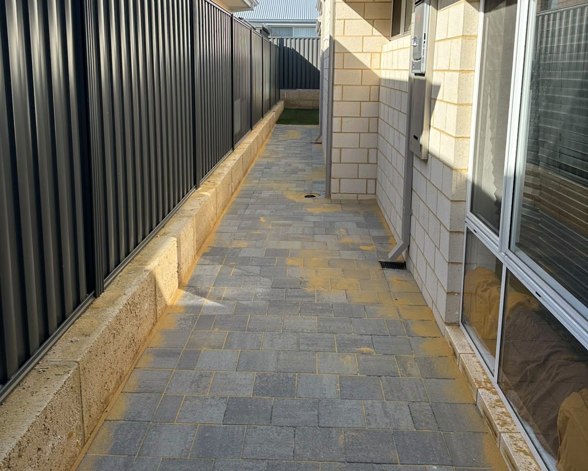 Grey paved side path laid by Landscraft Construction