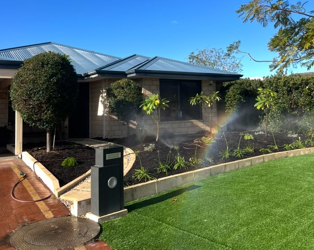 New lawn and retic sprinklers running in a front yard