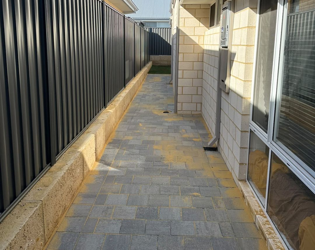 Paved side path beside a limestone retaining wall