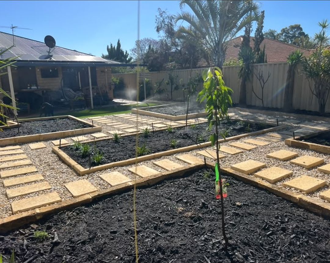 Backyard renovation with new garden beds, gravel and stepping pavers